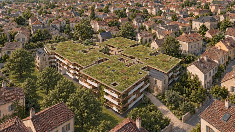 Dasselbe Haus aus größerer Nähe von oben: das Dach ist durchgehend bepflanzt und von Höfen durchbrochen, ringsum stehen die Nachbarhäuser des Ortskerns mit ihren Ziegeldächern.